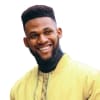 A man in a yellow jacket smiling.